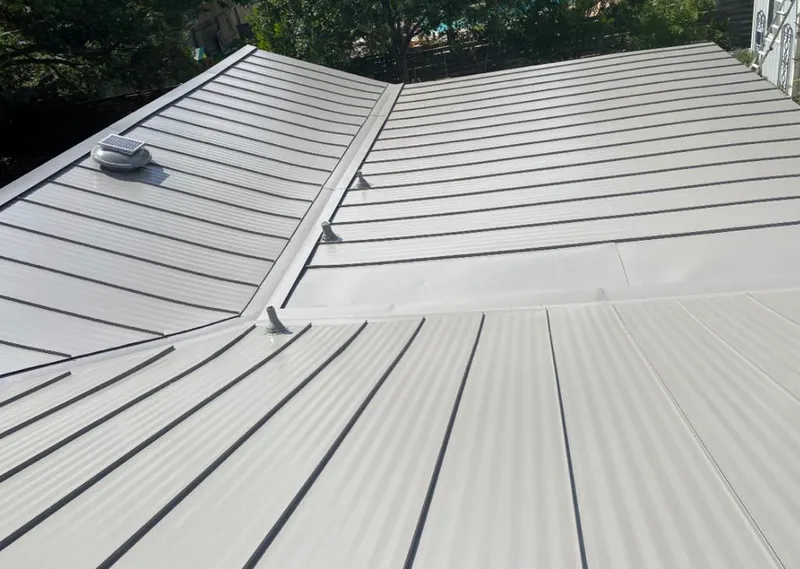 Solar attic fan installed on a metal roof for Roof Ventilation in Pikeville